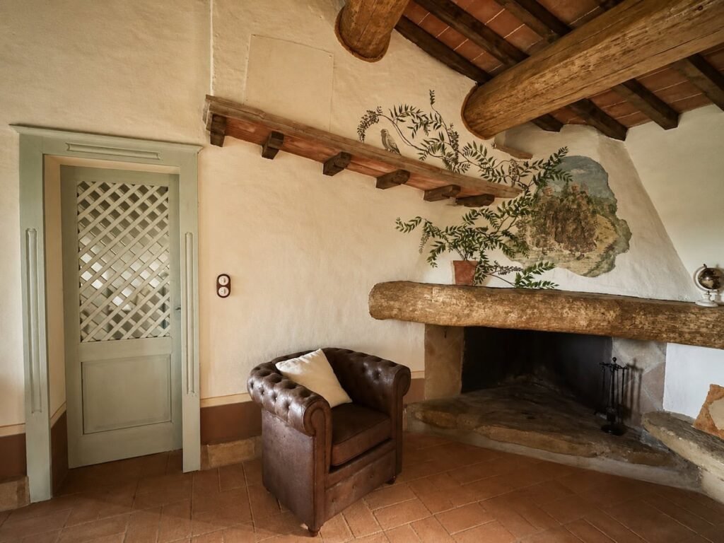 Soggiorno con camino e vano porta nell'appartamento Il belvedere, Borgo Braila, Umbria