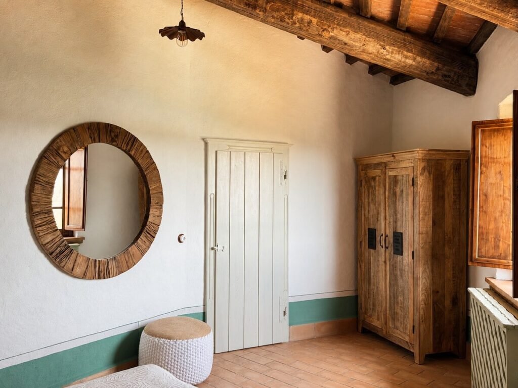 Camera da letto con specchio rotondo e armadio nell'appartamento Il belvedere, Borgo Braila, Umbria